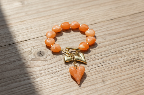 Beaded bracelet with hanging heart charms