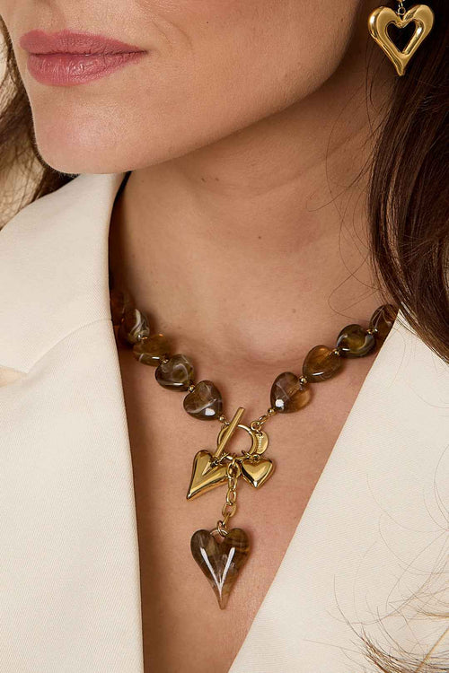 Bead necklace with hanging heart charms