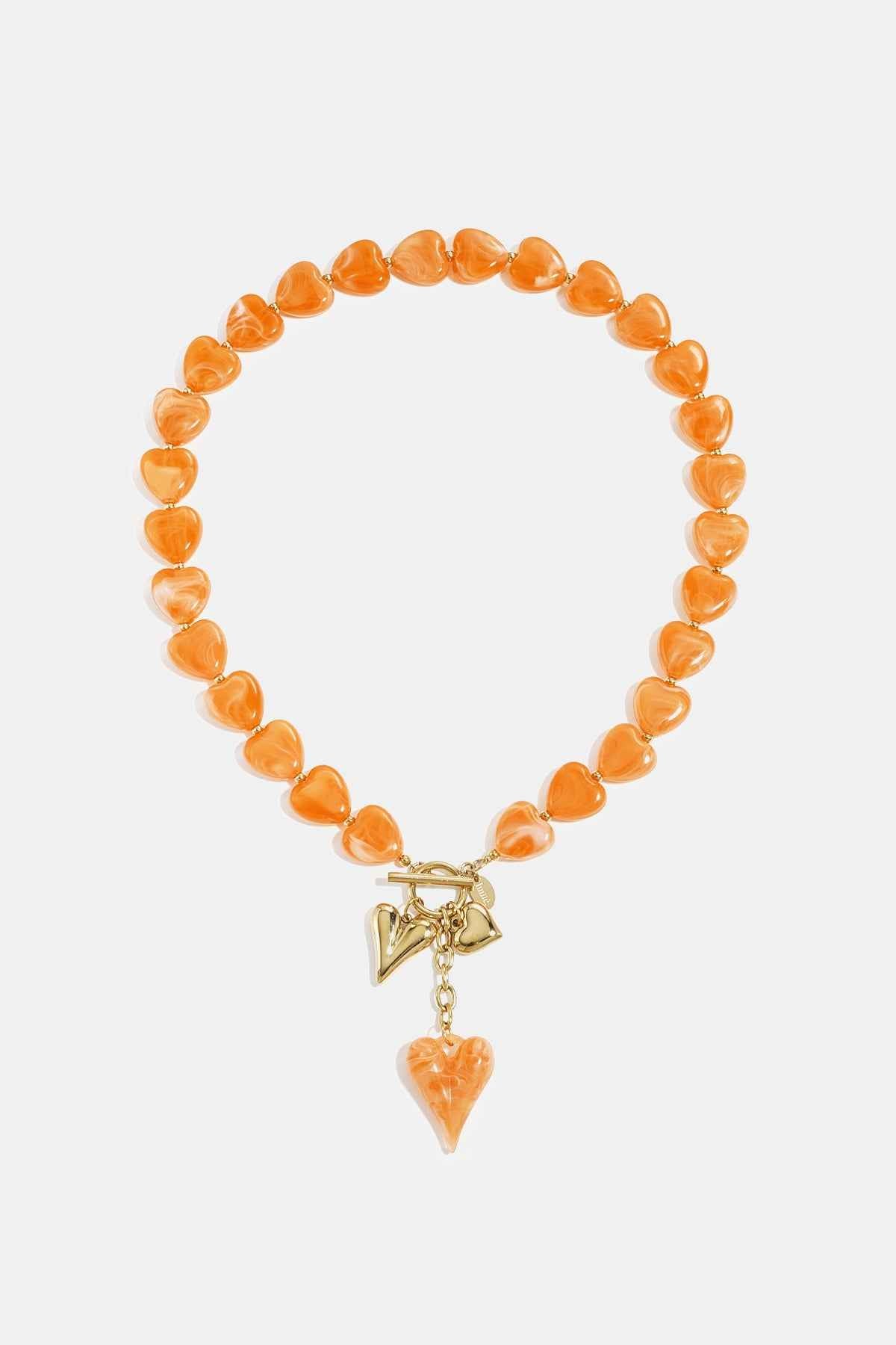 Bead necklace with hanging heart charms
